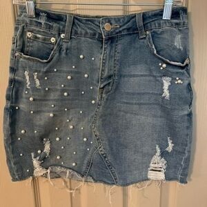 Hammer Jeans light wash distressed denim mini skirt with pearls.